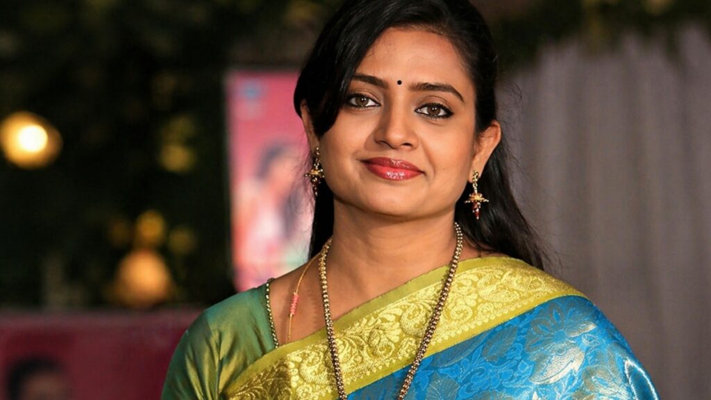 Actress Indraja wearing blue saree portrait horizontal image