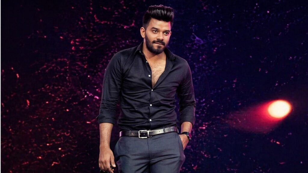 Sudigali Sudheer standing on stage in black shirt horizontal image